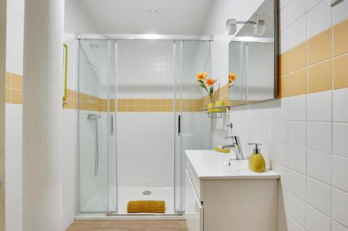 a white bathroom with a shower and a sink at Charming New Apartment in the Heart of Lisbon in Lisbon