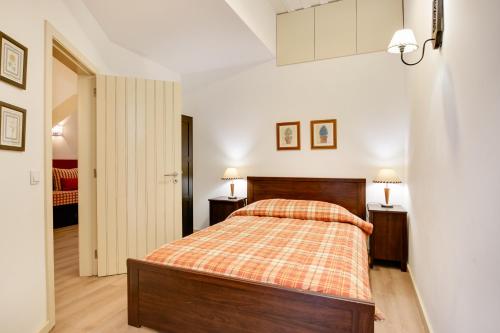 a bedroom with a bed and two night stands at Charming New Apartment in the Heart of Lisbon in Lisbon