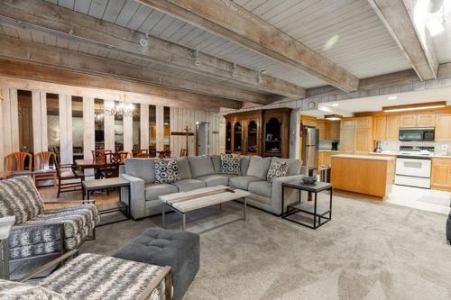 a large living room with couches and a kitchen at Villa Cortina Condo Next to Vail Village in Vail