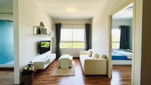 a living room with a couch and a tv at The Trust condo 2 bed room Hua hin in Hua Hin