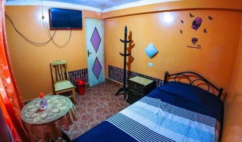 a bedroom with a bed and a table in it at HOTEL ORO BLANCO in Uyuni