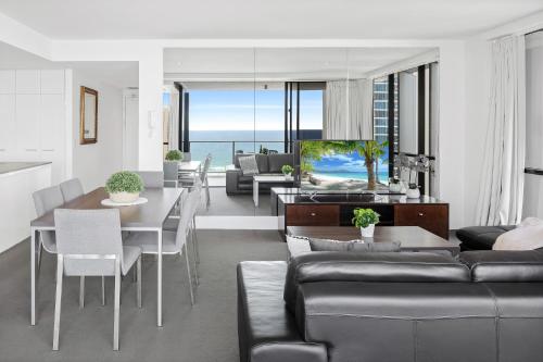 a living room with a couch and a table at Ocean View Apartments - Self Contained & Privately Managed in Gold Coast