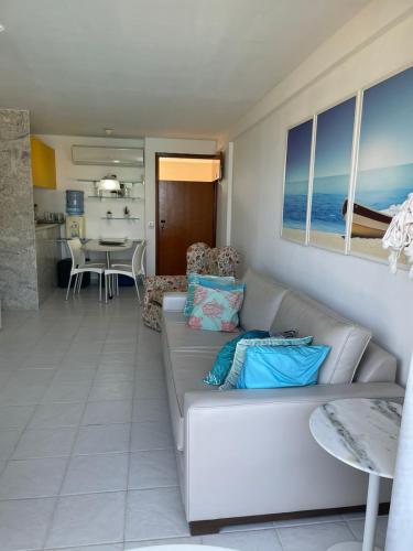a living room with a couch and a table at Flat Marupiara suítes com a melhor vista de Muro Alto in Porto De Galinhas