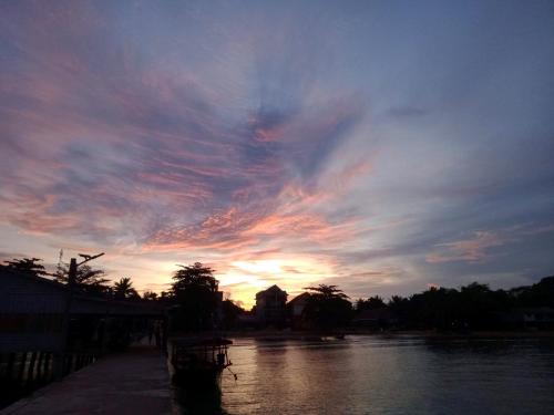 a sunset over a river with a cloudy sky at Baloo Guesthouse in Koh Rong Sanloem