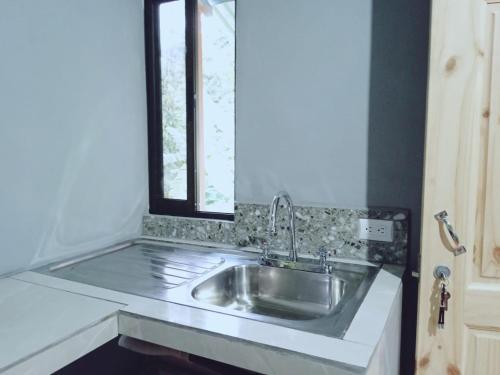 a kitchen counter with a sink and a window at Paraíso Rio Celeste in San Rafael