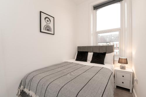 a white bedroom with a bed and a window at Fantastic New, London Apartment 3 Bed 1 Bath & Parking in Whetstone
