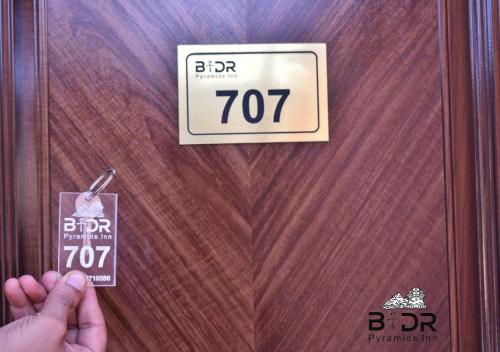 a door with a sign that reads bhr at Badr pyramids view in Cairo
