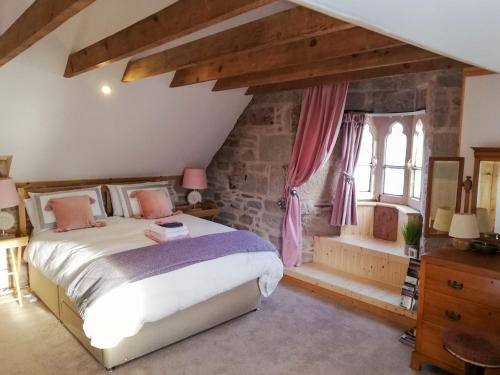 a bedroom with a large bed and a window at St Brighs in Dingwall
