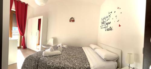 a bedroom with a bed with a black and white blanket at Sunrise Home in Cosenza