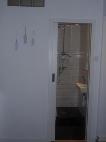 a bathroom with a shower and a sink at Mieszkanie Przy Plaży in Gdańsk