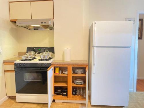 a kitchen with a stove and a refrigerator at Entire Beautiful 2BR Private Apartment [R] in Whitestone
