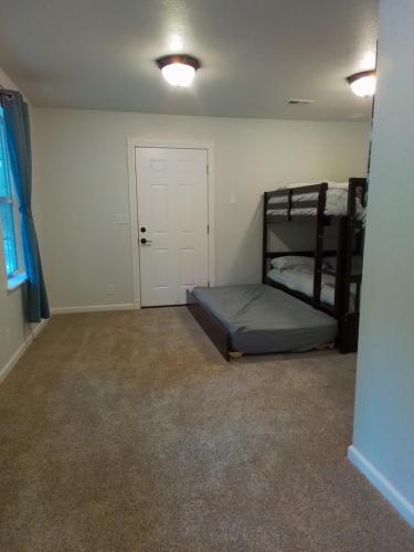 a bedroom with two bunk beds and a door at Riffle Road Ranch in Spirit Lake