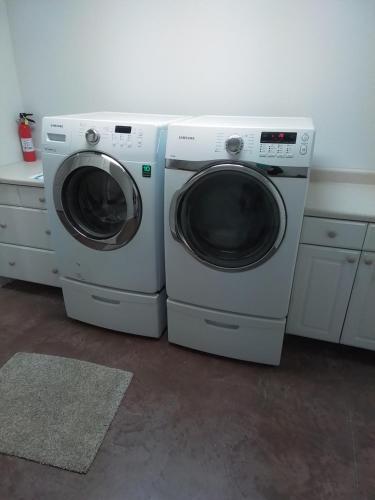 two washing machines sitting next to each other in a room at Riffle Road Ranch in Spirit Lake