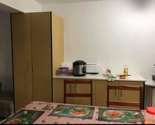 a kitchen with a table and a counter top at Barrett Accommodation Budget Rooms in Suva