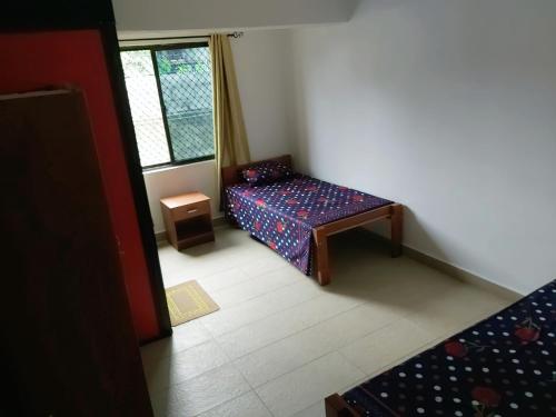 a small room with a bed and a window at Barrett Accommodation Budget Rooms in Suva