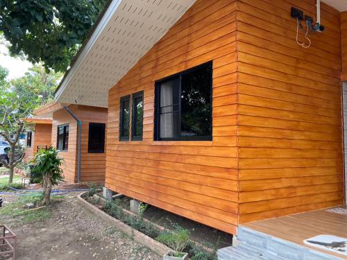 a wooden house with a window on the side of it at T&P at Pai in Pai