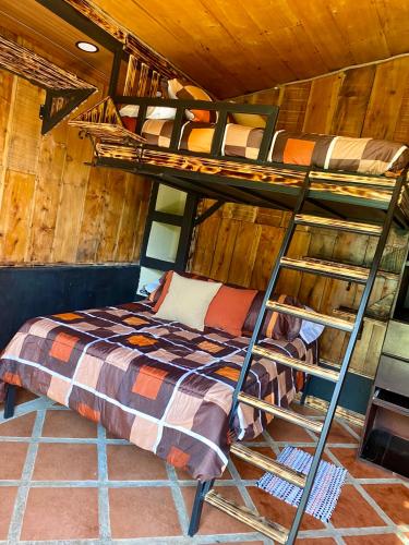 a bedroom with two bunk beds in a cabin at Cabañas Tierra Fértil #2 