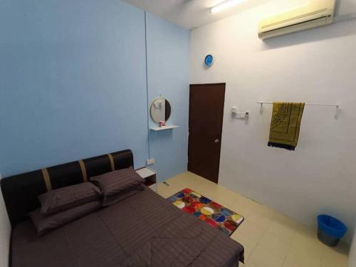 a bedroom with a bed and a mirror on the wall at Home MH Casa Damai Private Pool at Sungai Petani in Sungai Petani
