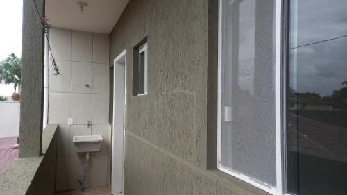 a bathroom with a toilet on the side of a building at Sol Nascente Apartamentos - Pontal do Sul in Pontal do Paraná