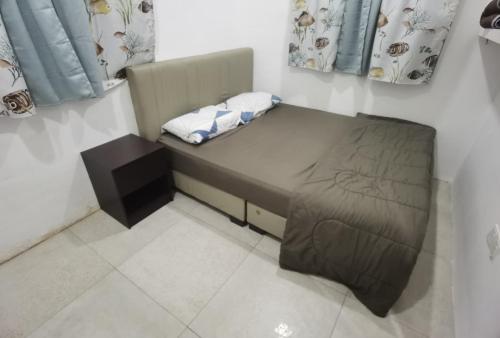 Akmal Homestay Klang tesisinde bir odada yatak veya yataklar