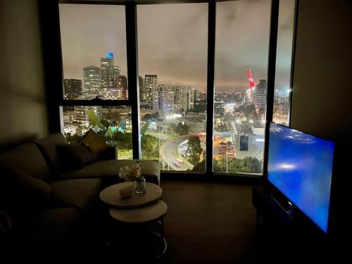 a living room with a view of a city at Luxury 3 Bed 2 Bath + car park at Melbourne Square in Melbourne