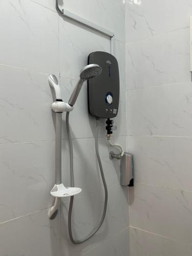 a blow dryer on a wall in a bathroom at Guest House Gua Kelam in Kaki Bukit