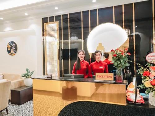 two women standing behind a counter in a store at Lake View Hotel & Travel in Hanoi