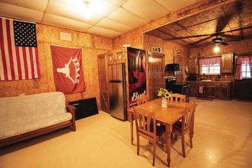 a room with a table and a bed and a flag at Lake Texoma's Barn-dominum in Pottsboro in Pottsboro