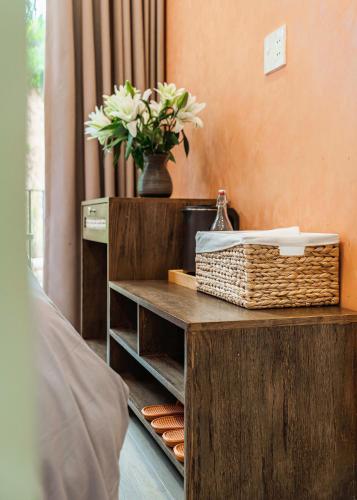 a table with a basket and a vase with flowers at Miền Sương Khói - Home & Café in Khu Chi Lăng