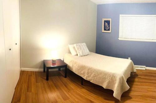 a bedroom with a bed and a table in it at Quiet & Cozy home near Hospitals in Cleveland