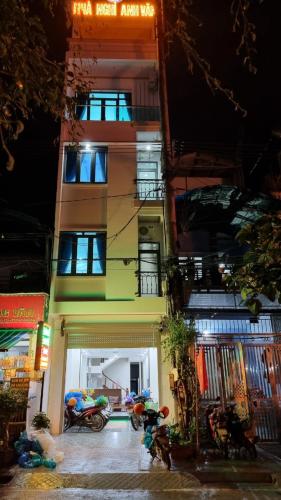 a tall building with motorcycles parked in front of it at NHÀ NGHỈ ANH VĂN in Dồng Văn