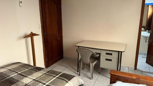a bedroom with a desk and a bed and a desk at Vacation Home La Ceiba in La Ceiba