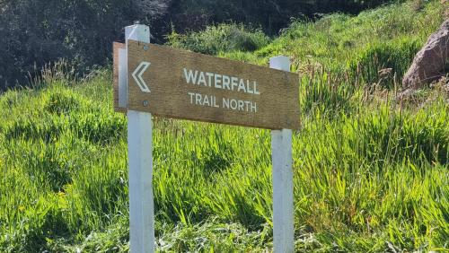 a sign for a trail north on a hill at Glenwood Akaroa Bush Retreat - Kanuka Hut in Akaroa