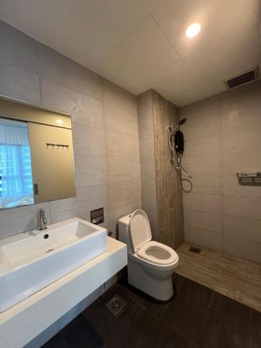 a bathroom with a white sink and a toilet at Arte Plus Jalan Ampang KLCC in Kuala Lumpur