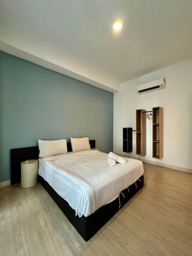 a bedroom with a large bed with white sheets at Arte Plus Jalan Ampang KLCC in Kuala Lumpur