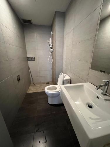 a bathroom with a white toilet and a sink at Arte Plus Jalan Ampang KLCC in Kuala Lumpur