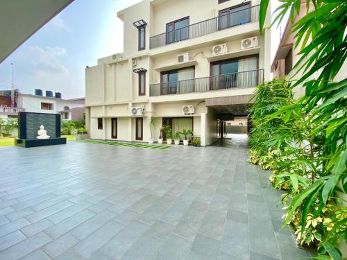 an external view of a building with a courtyard at Vastu Serene Studio Apartment in Dehradun