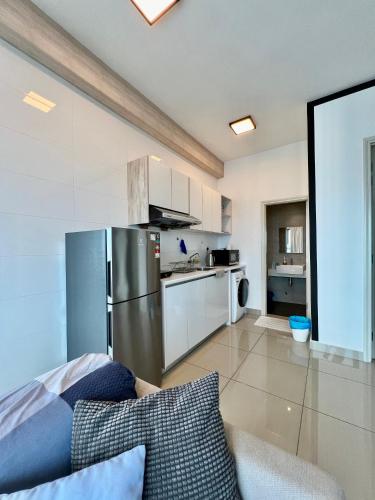 a kitchen with a stainless steel refrigerator in a room at Arte Plus Jalan Ampang KLCC in Kuala Lumpur
