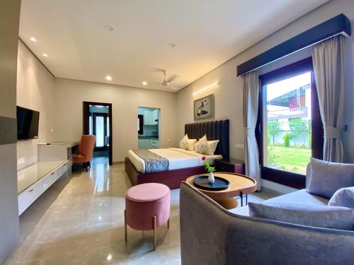 a hotel room with a bed and a couch at Vastu Serene Studio Apartment in Dehradun