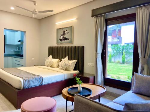 a hotel room with a bed and a window at Vastu Serene Studio Apartment in Dehradun
