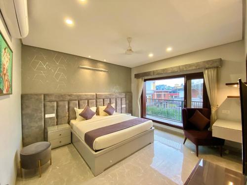 a bedroom with a bed and a desk and a window at Vastu Serene Studio Apartment in Dehradun
