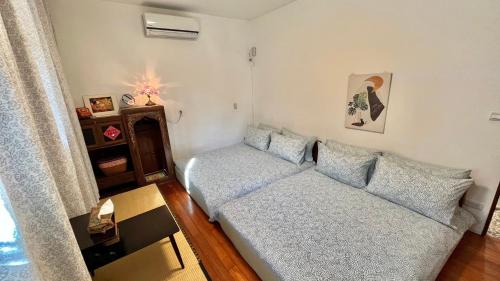 a living room with a couch and a table at Sun Moment 鬆貓們民宿 in Toucheng