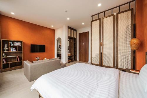 a bedroom with a large white bed and a couch at Miền Sương Khói - Home & Café in Khu Chi Lăng
