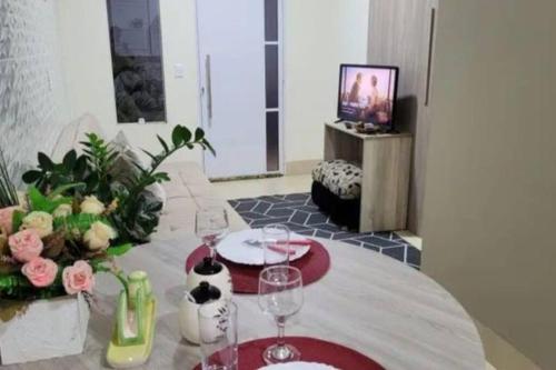 a room with a table with wine glasses on it at Flat Morada da Neblina! in Chapada dos Guimarães