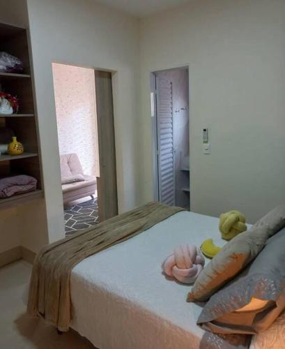 a bedroom with a bed with two stuffed animals on it at Flat Morada da Neblina! in Chapada dos Guimarães