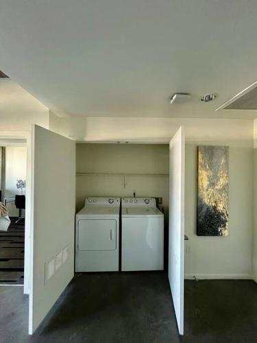 a laundry room with a washer and dryer in it at Downtown Haven of the City in Phoenix