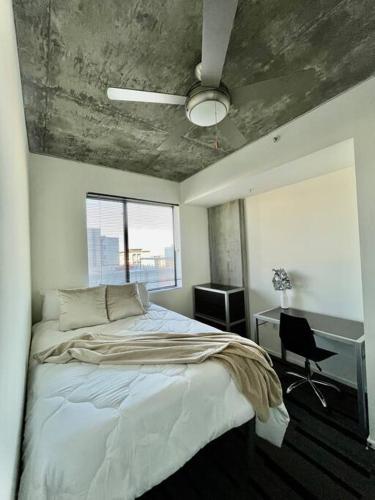 a bedroom with a bed and a desk and a ceiling at Downtown Haven of the City in Phoenix