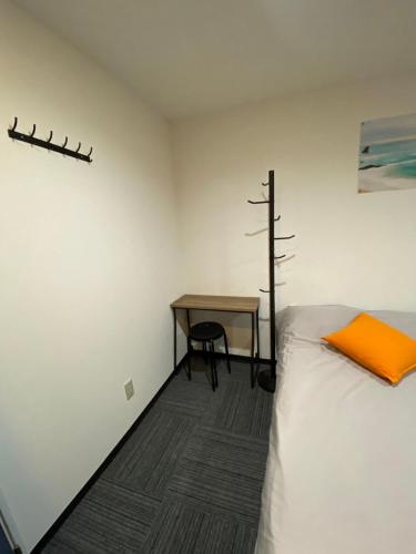 a bedroom with a bed and a desk and a table at MR TOMO FUJI in Fuji