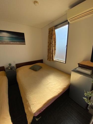 a small bedroom with a bed and a window at MR TOMO FUJI in Fuji