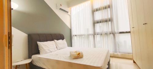 a small bedroom with a bed with a box on it at The Robertson Kuala Lumpur by PremierHome 5-6pax in Kuala Lumpur